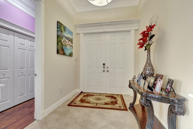 tiled entryway featuring ornamental molding