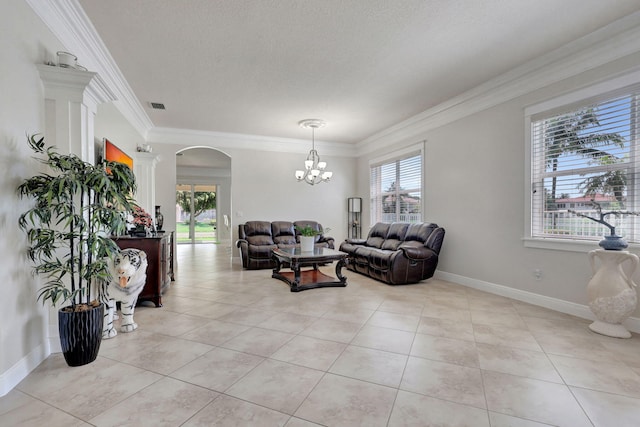 living room with ornamental molding, a textured ceiling, light tile patterned floors, and an inviting chandelier