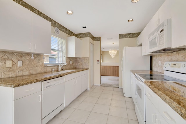 kitchen with white cabinets, white appliances, sink, and tasteful backsplash