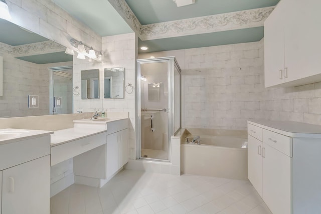 bathroom with tile walls, tile flooring, dual vanity, and plus walk in shower