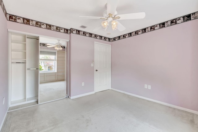 carpeted spare room with ceiling fan