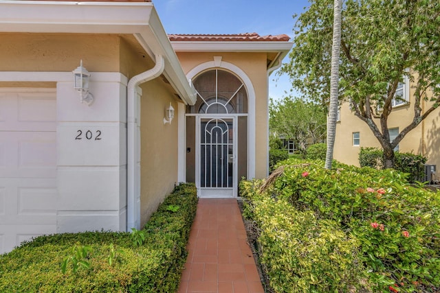 view of exterior entry featuring a garage