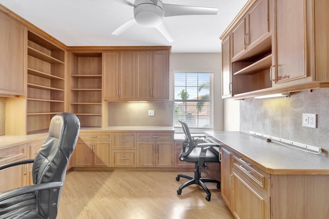 office area featuring ceiling fan, light hardwood / wood-style floors, and built in desk