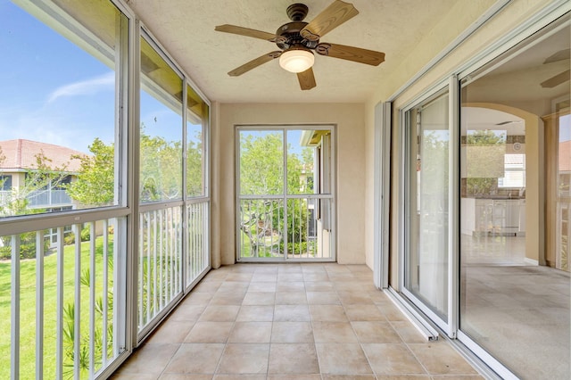 unfurnished sunroom with a wealth of natural light and ceiling fan