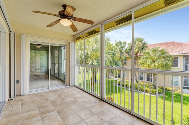 unfurnished sunroom with a healthy amount of sunlight and ceiling fan