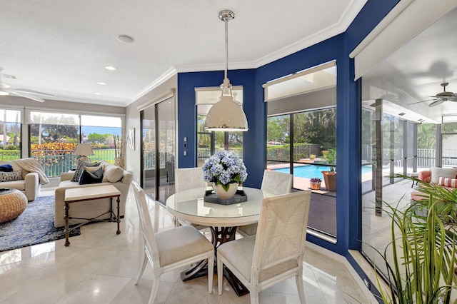 tiled dining space with ornamental molding and ceiling fan