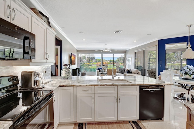 kitchen with black appliances, sink, and white cabinets