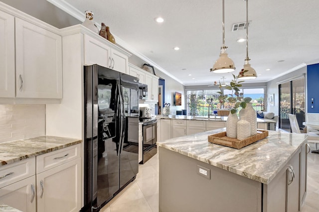 kitchen featuring black appliances, tasteful backsplash, decorative light fixtures, white cabinets, and a center island