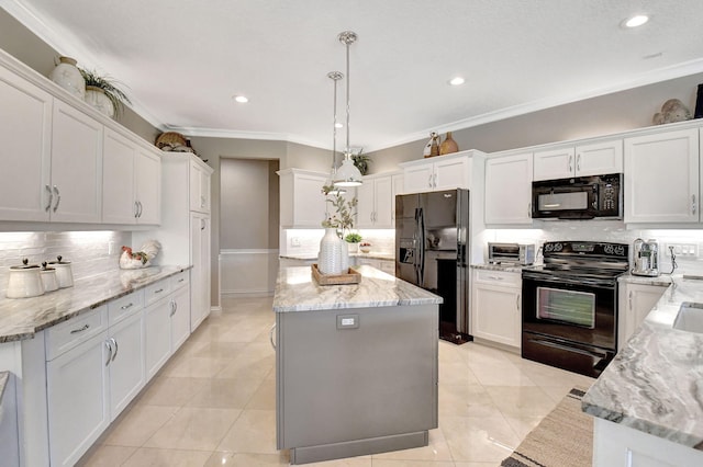 kitchen featuring black appliances, white cabinetry, and pendant lighting