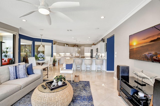 living room featuring ceiling fan, light tile patterned floors, and ornamental molding