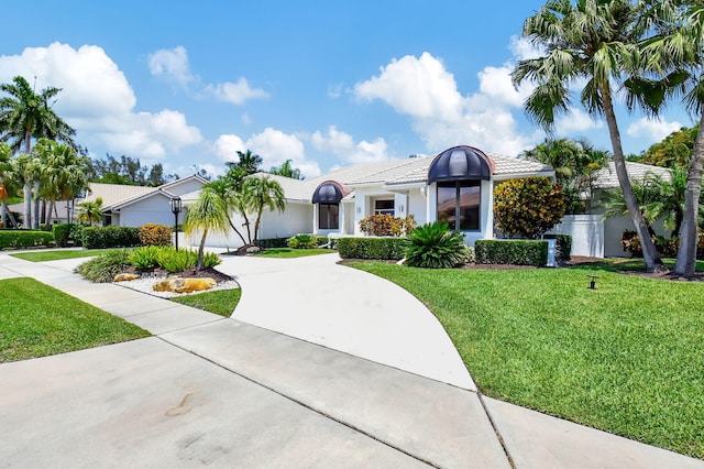 view of front of house featuring a garage and a front lawn