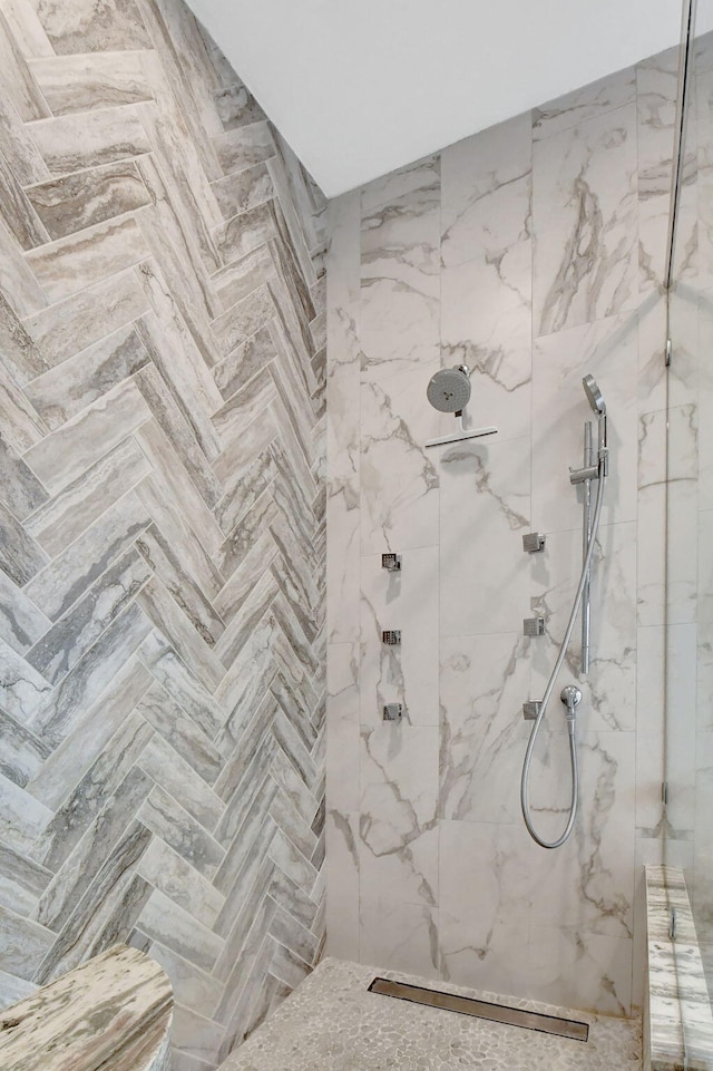 bathroom with parquet flooring and a tile shower