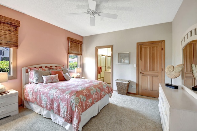 bedroom with ensuite bathroom, ceiling fan, a textured ceiling, and light colored carpet