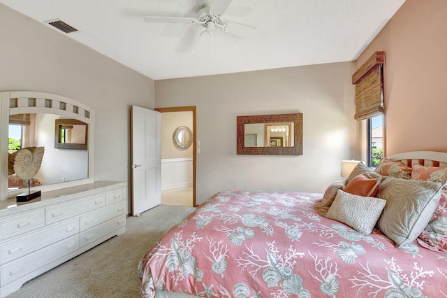 bedroom with ceiling fan and light carpet