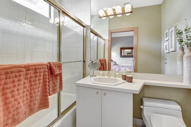 full bathroom with shower / bath combination with glass door, vanity, and toilet