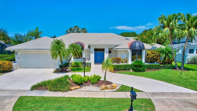 view of front of property featuring a garage and a front yard