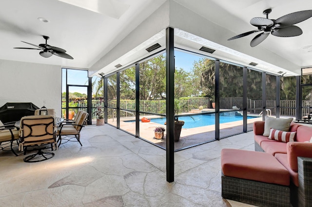 sunroom featuring ceiling fan and a healthy amount of sunlight