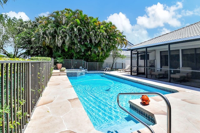 view of pool featuring a patio and a sunroom