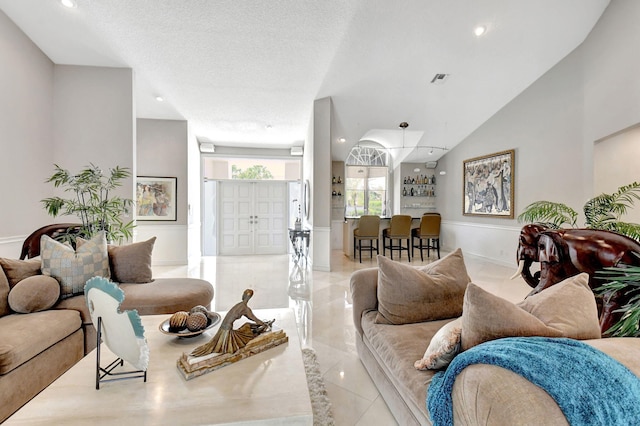 tiled living room with a textured ceiling