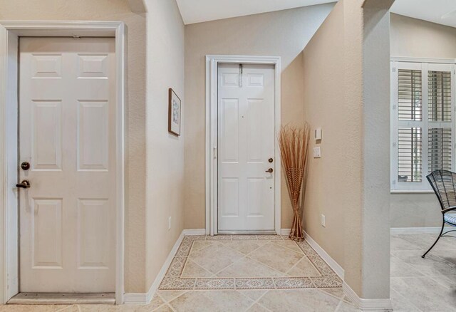 doorway with lofted ceiling