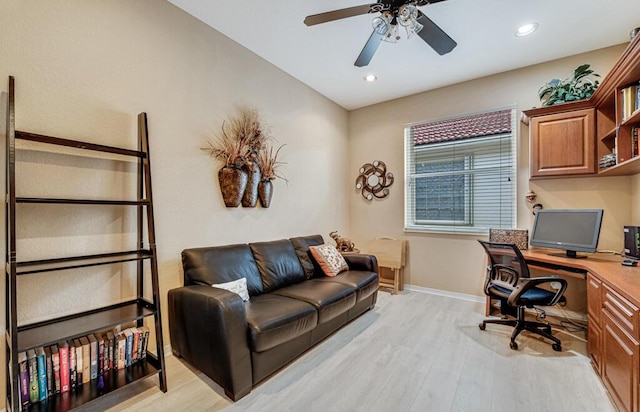 office area with ceiling fan, built in desk, and light hardwood / wood-style floors