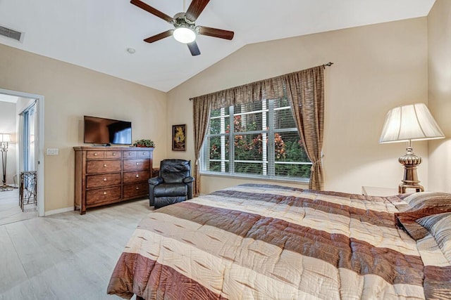 bedroom featuring ceiling fan, light hardwood / wood-style flooring, and vaulted ceiling