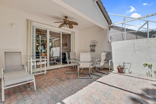 view of patio / terrace with a lanai and ceiling fan