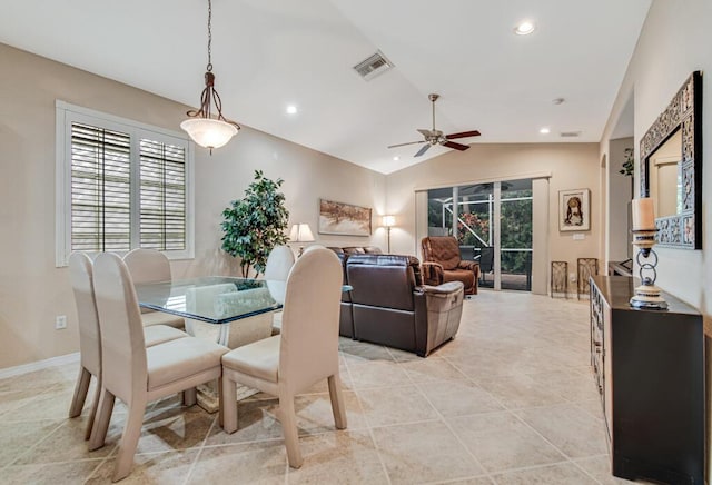 dining space with ceiling fan and vaulted ceiling