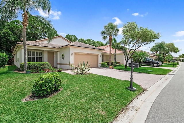 view of front of house with a front yard and a garage