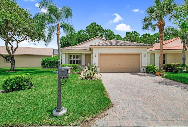 view of front of house with a front lawn and a garage