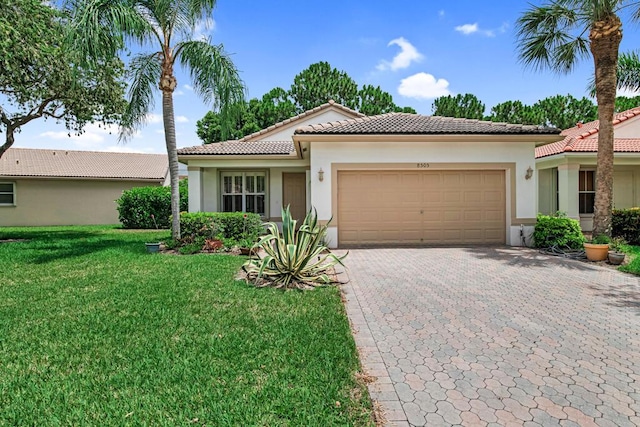 mediterranean / spanish-style home with a garage and a front yard