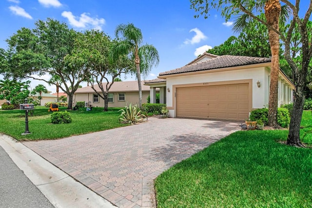 view of front of house with a garage and a front yard