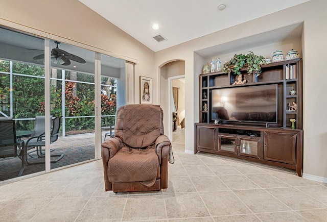 living area with vaulted ceiling, ceiling fan, light tile patterned floors, and plenty of natural light