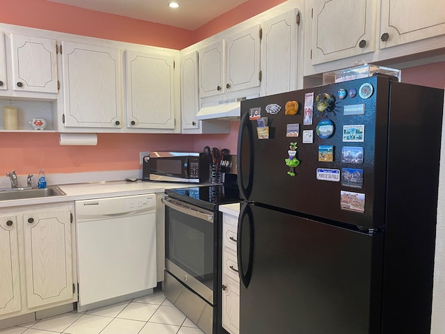 kitchen featuring stainless steel appliances, light tile patterned flooring, sink, and white cabinetry