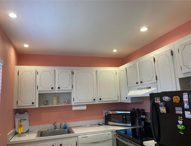 kitchen with sink, black refrigerator, dishwasher, stove, and white cabinets