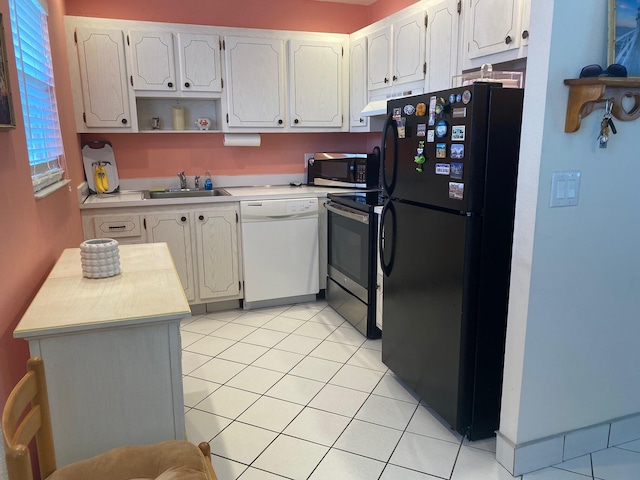 kitchen with sink, light tile patterned floors, stainless steel appliances, and white cabinets