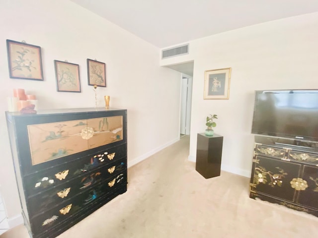 sitting room featuring light colored carpet