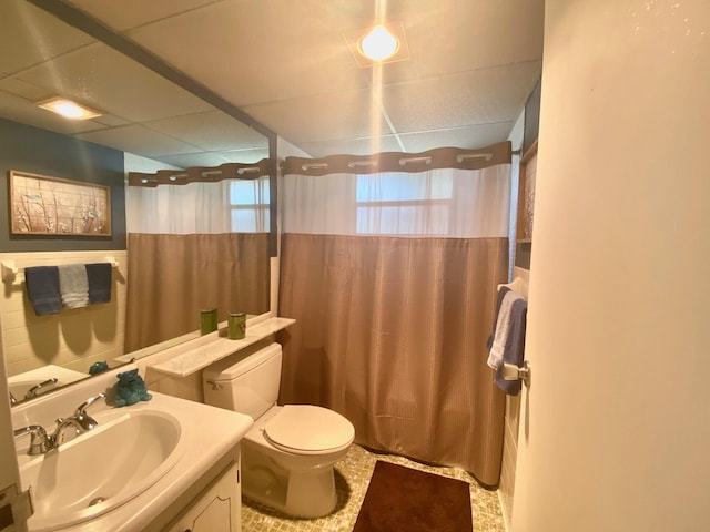 bathroom with tile flooring, vanity, and toilet