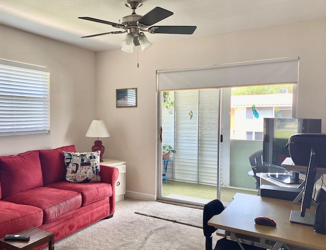 carpeted living room with ceiling fan