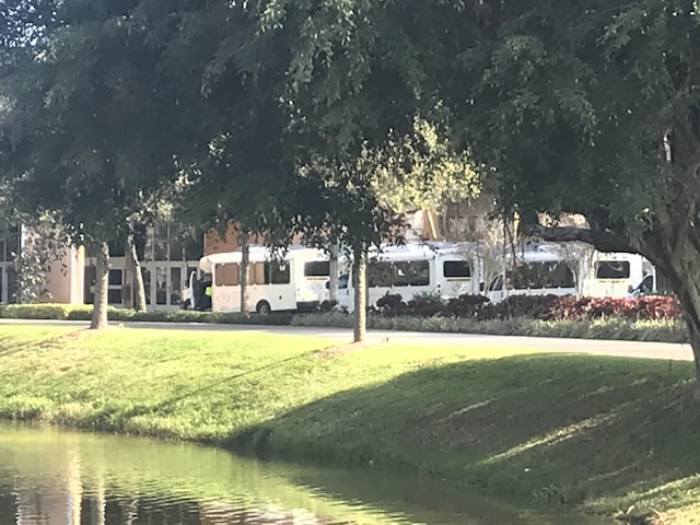 view of community featuring a yard and a water view