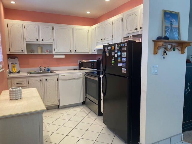 kitchen featuring light tile flooring, dishwasher, range with electric stovetop, black refrigerator, and sink