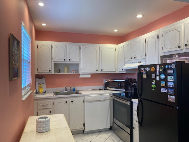 kitchen with electric stove, black refrigerator, sink, dishwasher, and light tile floors