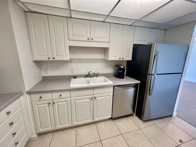 kitchen featuring white cabinets, sink, appliances with stainless steel finishes, and tasteful backsplash