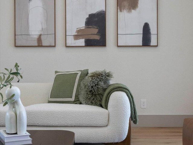 sitting room with wood-type flooring