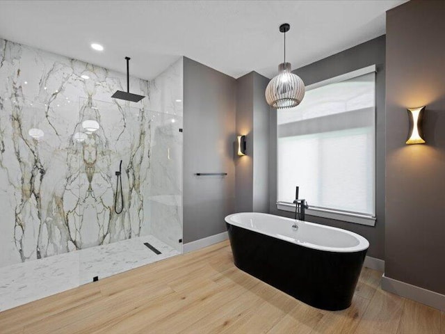 bathroom with plus walk in shower and wood-type flooring