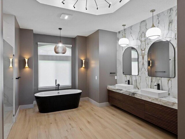 bathroom featuring hardwood / wood-style floors, vanity, and a washtub