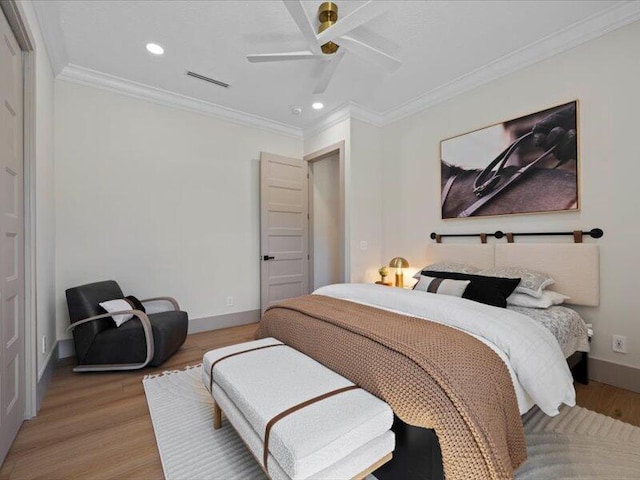 bedroom featuring ceiling fan, light hardwood / wood-style floors, and ornamental molding