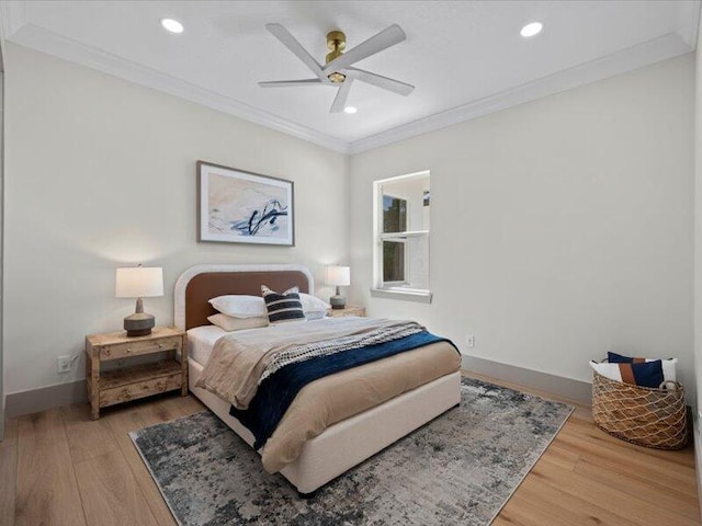 bedroom with ceiling fan, wood-type flooring, and ornamental molding