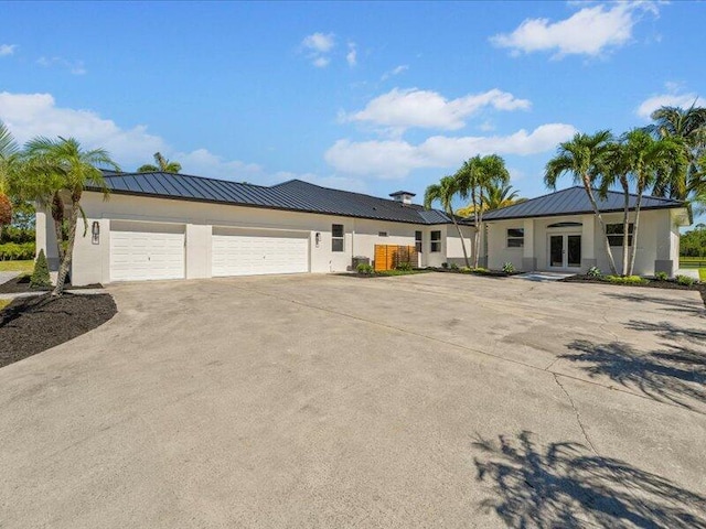 view of front of home featuring a garage and french doors