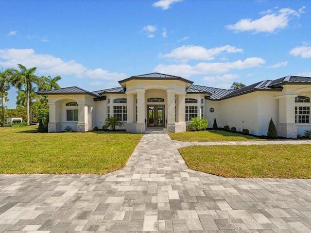 prairie-style home with a front lawn and french doors